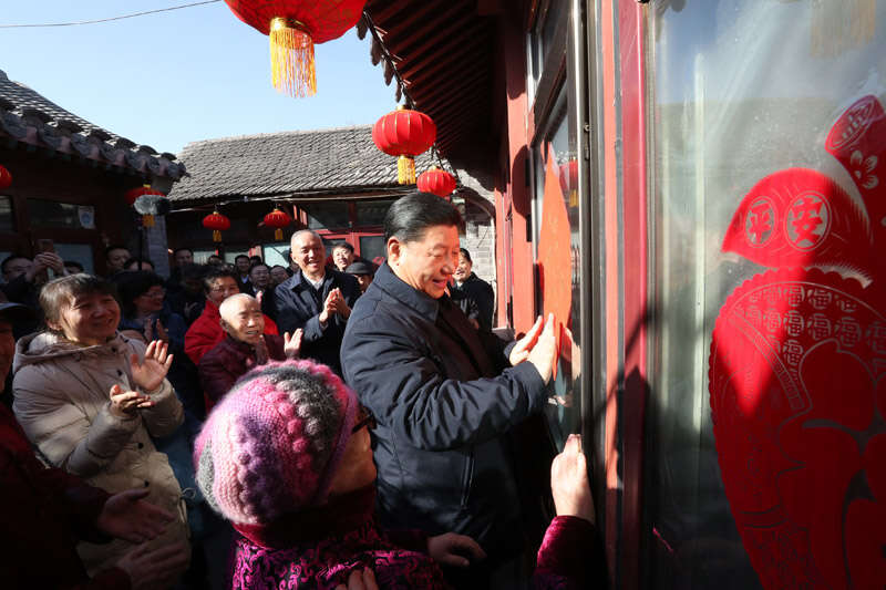 2019年2月1日上午，習近平在北京前門東區草廠四條胡同32號院，高興地拿起一幅“福”字，親自貼到門上，給這里的老街坊們拜年。新華社記者 鞠鵬 攝